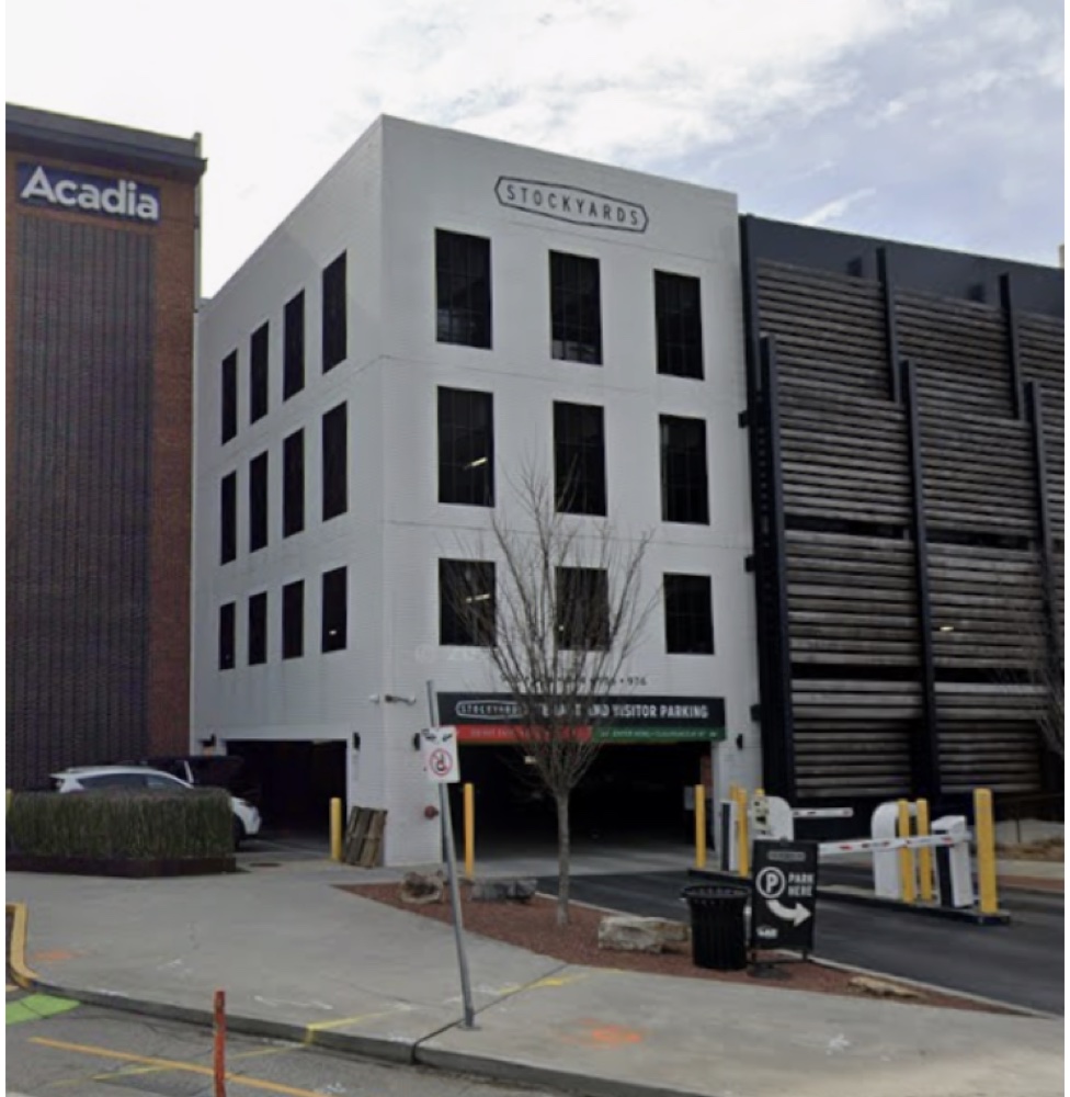 The Stockyards Parking Garage &mdash; a four-story white building with 'STOCKYARDS' signage above the entrance